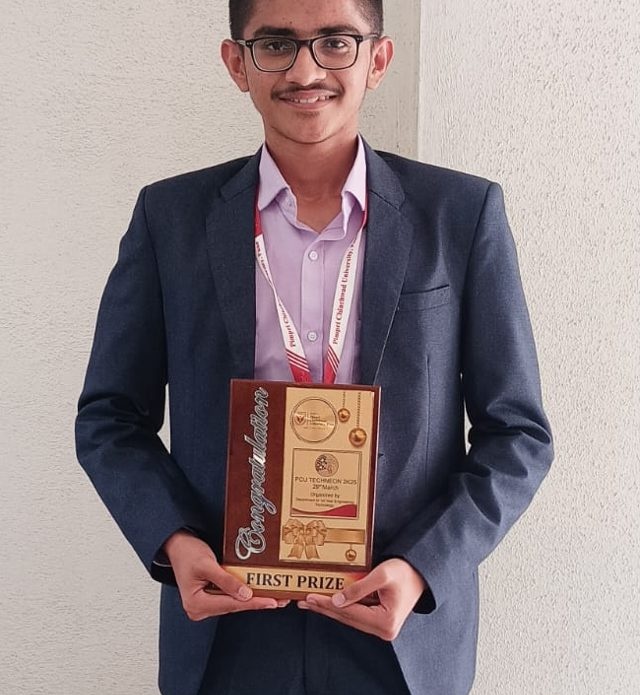Pruthvi Jadhav holding the First Prize trophy at PCU Techneon